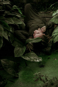 Midsection of woman amidst leaves on field