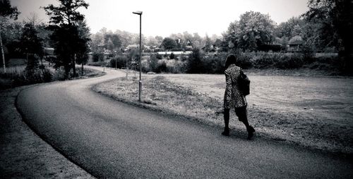 Full length of woman walking on road