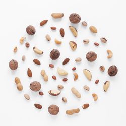 High angle view of coffee beans against white background