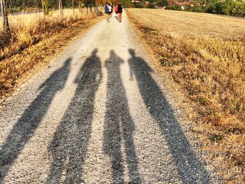Shadow of people on road in city