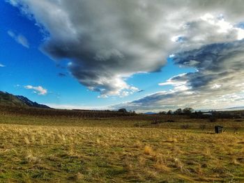 Scenic view of landscape against cloudy sky