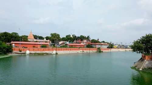 View of temple by building against sky