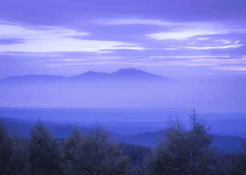 Scenic view of sea and mountains against sky