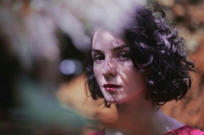 Close-up portrait of woman with curly hair