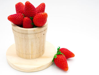 Close-up of strawberries on table against white background