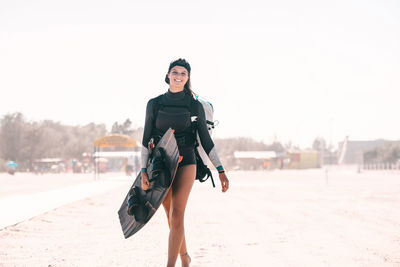 Portrait of woman standing at beach