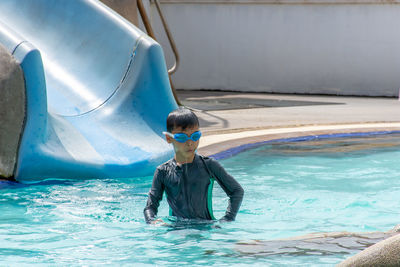 Boy swimming in pool