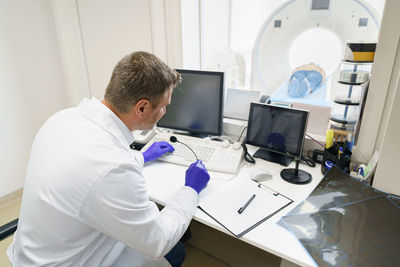 Side view of man working at clinic