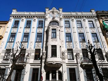 Low angle view of buildings against blue sky