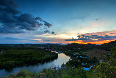 Scenic view of river against sky at sunset