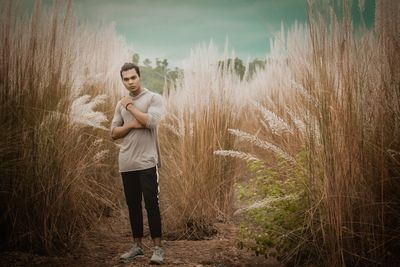 Full length of young man standing on field