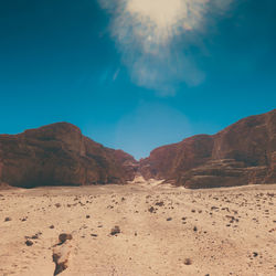 View of desert against blue sky