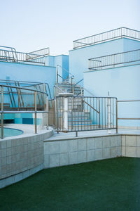 Staircase by building against clear blue sky