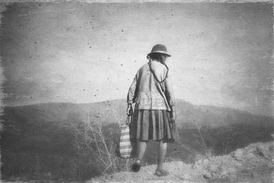 Full length of woman standing on railing