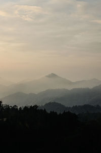 Scenic view of silhouette mountains against sky