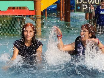 Portrait of people enjoying in swimming pool