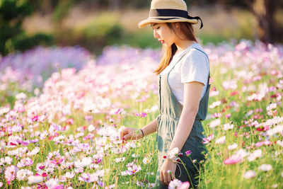 Woman standing amidst plants