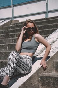 Portrait of a young woman sitting on staircase