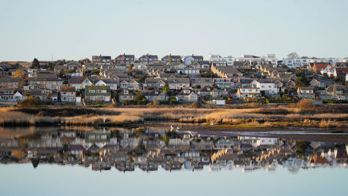 Panoramic view of townscape by lake against sky