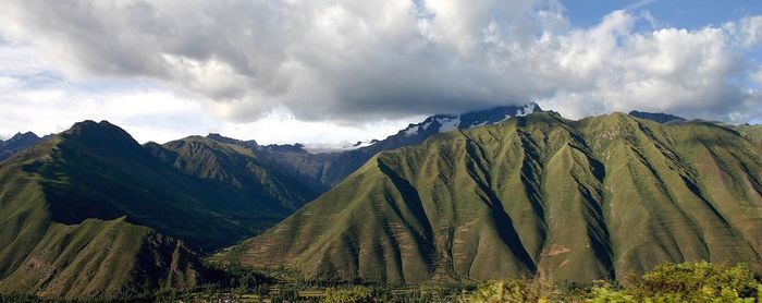 Scenic view of mountains against cloudy sky