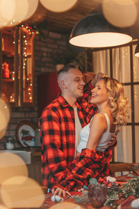 Candid authentic happy married couple spends time alone at lodge xmas decorated