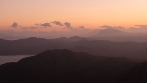 Scenic view of silhouette mountains against sky at sunset