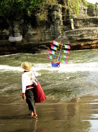 Rear view of people enjoying in river