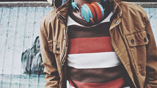 Midsection of man with headphones