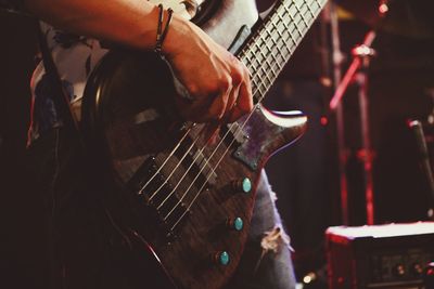 People playing guitar at music concert