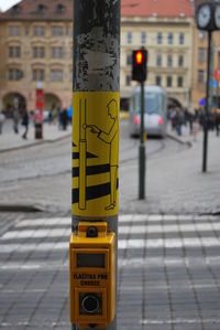 Close-up of sign board on street