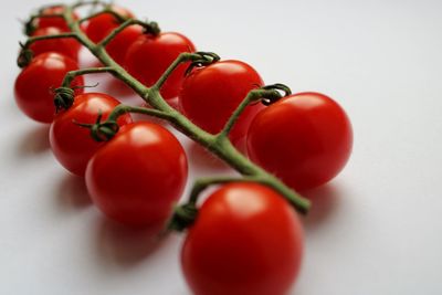 Close-up of cherry tomatoes against white background