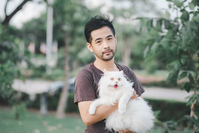 Portrait of young man with dog