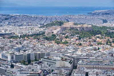 High angle view of townscape by sea against sky