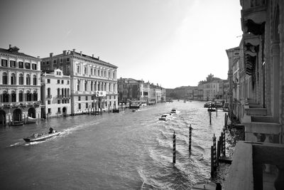 Canal amidst buildings in town against sky