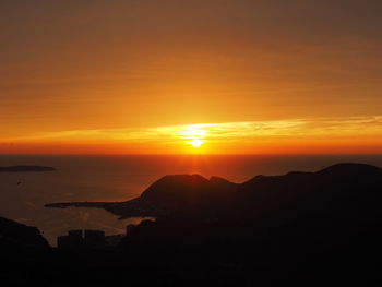 Scenic view of sea against romantic sky at sunset