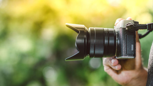 Close-up of man photographing camera