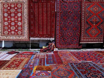 View of carpets with woman making carpet