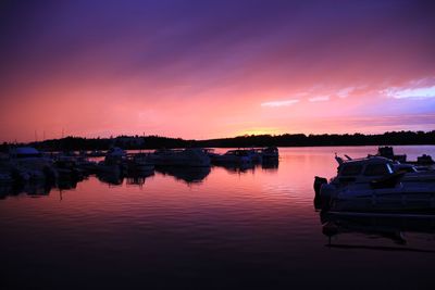 Boats in lake at sunset