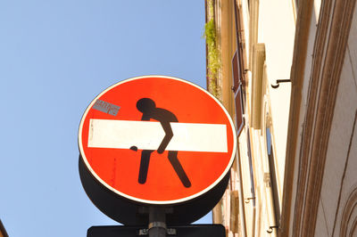 Close-up of road sign against clear sky