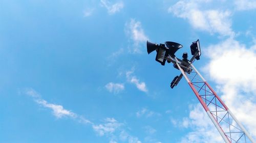 Low angle view of mega phone against blue sky