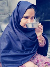 Midsection of man holding coffee cup