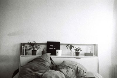 Man photographing book in bedroom