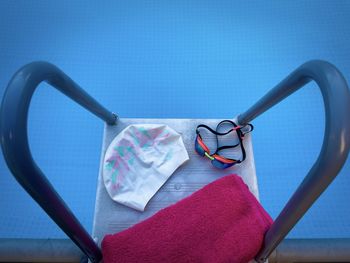 Directly above shot of equipment on ladder in swimming pool