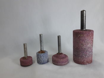 Close-up of objects on table against wall