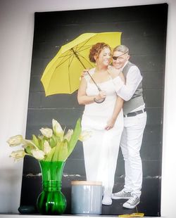 Couple standing by potted plant