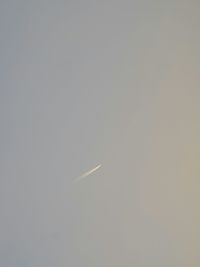 Low angle view of airplane flying against clear sky