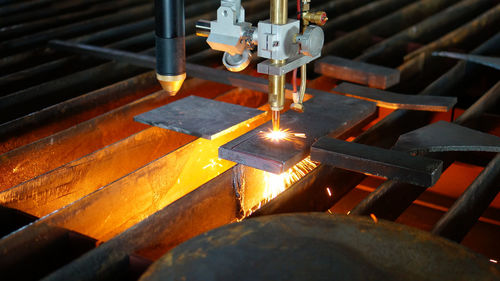 Close-up of machine welding metal at factory