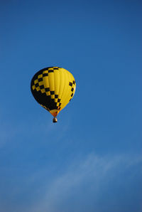 Low angle view of hot air balloon against blue sky