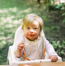 Portrait of cute girl sitting on chair
