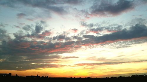 Silhouette of landscape against cloudy sky